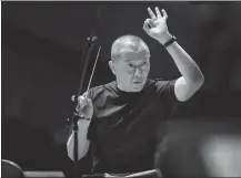  ?? ?? Left and left below: Tan leads rehearsals with the Beijing Symphony Orchestra for the concert celebratin­g Beijing’s cultural heritage.