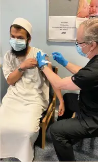  ??  ?? Imam Ashraf from Port Talbot Mosque being vaccinated at Fairfield Surgery, Port Talbot.