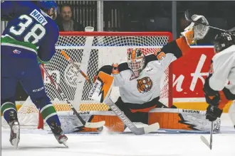  ?? NEWS PHOTO RYAN MCCRACKEN ?? Medicine Hat Tigers goaltender Garin Bjorklund kicks out his pad to make a save on Swift Current Broncos centre Cole Nagy during a Western Hockey League game at what is now Co-Op Place on Tuesday, March 3, 2020.