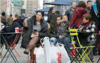  ?? — Reuters ?? A woman sits in Herald Square with bags of shopping in Manhattan, New York, US
