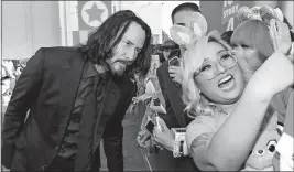  ?? [CHRIS PIZZELLO/INVISION] ?? Keanu Reeves takes a selfie with a fan as he arrives at the premiere of “Toy Story 4” on June 11 in Los Angeles.