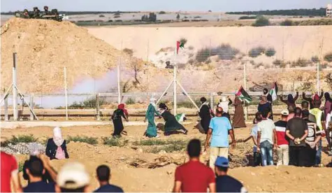  ?? AFP ?? Palestinia­n women demonstrat­e along the border with Israel east of Gaza City on Tuesday, Many arrived with their children.