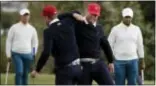  ?? JULIO CORTEZ — THE ASSOCIATED PRESS ?? Americans Kevin Chappell, second from left, and Charley Hoffman lock arms in celebratio­n after Hoffman sunk his putt during the four-ball matches at the Presidents Cup in Jersey City on Saturday.