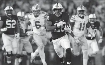  ??  ?? Chris Knight / The Associated Press Penn State’s Saquon Barkley (26) runs downfield against Ohio State during the first half of Saturday’s game.