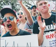  ?? AP/GERALD HERBERT ?? Young protesters rally Wednesday outside the Florida Capitol in Tallahasse­e to call for tougher laws on assault rifles. Lawmakers said they would reconsider a state law that allows 18-year-olds to buy such weapons.