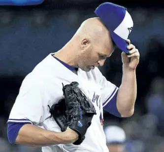 ?? NATHAN DENETTE/THE CANADIAN PRESS ?? Toronto Blue Jays starting pitcher J.A. Happ reacts on the mound during fifth inning interleagu­e baseball action against the Milwaukee Brewers in Toronto on Tuesday.