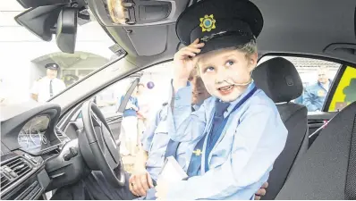  ?? PHOTO: DARAGH MCSWEENEY ?? ‘Magical’ memories: Fionn Doyle (7) in a Garda car on his birthday in August.