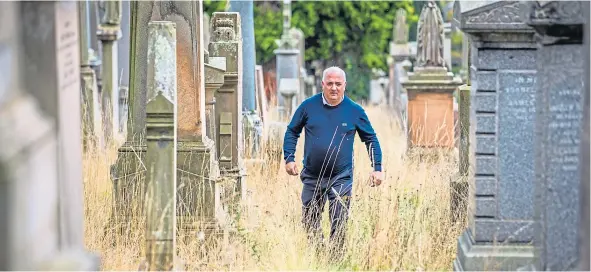  ??  ?? Kevin Gordon takes a walk through the overgrown Western Cemetery.