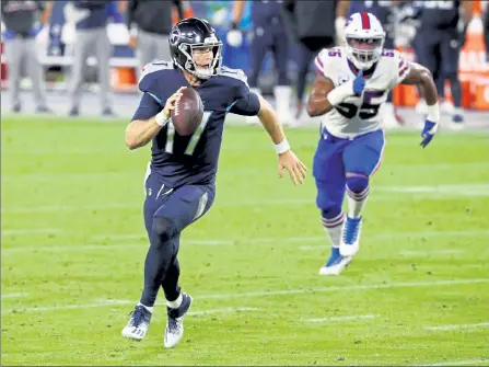  ?? GETTY IMAGES ?? Tennessee Titans quarterbac­k Ryan Tannehill runs with the ball during Tuesday’s game against the Buffalo Bills.