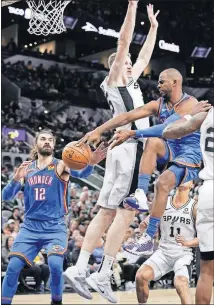  ?? [AP PHOTO/DARREN ABATE] ?? Oklahoma City Thunder guard Chris Paul, right, passes to center Steven Adams (12) as he is defended by San Antonio's Jakob Poeltl during Thursday's game at AT&T Center.