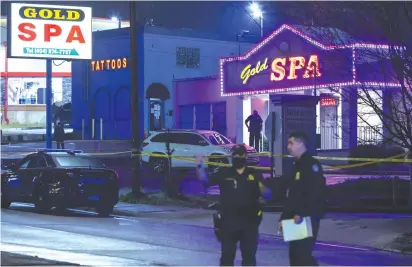  ?? (Chris Aluka Berry/Reuters) ?? POLICE OFFICERS are seen outside of Gold Spa after deadly shootings at massage parlors in the Atlanta, Georgia area yesterday.