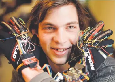  ??  ?? Kristof Klipfel, a 22-year-old CU Boulder student, has developed gloves that can turn any surface into a musical keyboard. “Pretty much all of my free time was going into trying to make this work,” he says. Hyoung Chang, The Denver Post