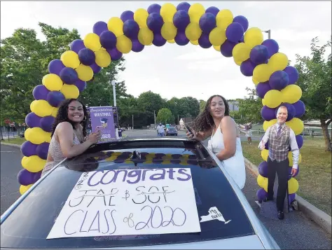  ?? Hearst Connecticu­t Media file photo ?? Parents, families and friends — along with a cut-out of Principal Michael Rinaldi — cheer on the seniors of Westhill High School as 500-plus graduates parade into the school parking lot to celebrate the Class of 2020 on June 19, 2020, in Stamford.