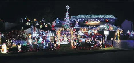  ??  ?? The annual holiday display at 8222 Burnlake Dr. in Burnaby has added a full-sized sleigh and reindeer on the front deck this year.