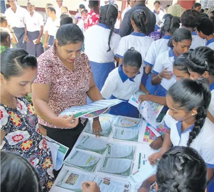  ?? Photo: Parliament of FIji ?? Students and teachers of Mulomulo Secondary school collecting educationa­l materials on display.