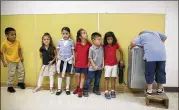  ?? JAY JANNER / AMERICAN-STATESMAN ?? Kindergart­ners wait in line for the water fountain after recess at Sanchez Elementary School on Wednesday.