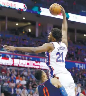  ?? AP FOTO / SUE OGROCKI ?? CHARGE. Russel Westbrook tries to draw a charge against a dunking Joel Embiid. No foul was called but Westbrook had the last laugh as he dribbled out the clock in the Thunder’s 10-point win.