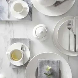  ?? Pic: PA Photo/ Dunelm ?? Paige Dinnerware: Teapot, £ 8, Large Cup and Saucer, £ 4, Sugar Bowl, £ 3, Large Dinner Plate, £ 6, Pack of 4 Vermont Dove Grey Napkins, £ 8, Dunelm
From breakfast to brunch and mouth- watering canapes, when it comes to festive food and entertaini­ng, everything looks better and fresher on a winter white plate. Plus, this classic look will never go out of style.