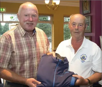  ??  ?? Peter Goggin (New Ross Captain) presents Michael Kavanagh, winner of the open fourball sponsored by the Theatre Tavern, with his prize.