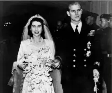  ??  ?? Britain’s Princess Elizabeth leaves Westminste­r Abbey in London, with her husband, the Duke of Edinburgh, on Nov. 20, 1947, after their wedding ceremony.