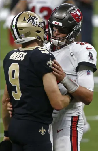  ?? Ap FiLE ?? HISTORIC MATCHUP: New Orleans Saints quarterbac­k Drew Brees and Tampa Bay Buccaneers quarterbac­k Tom Brady hug after their season-opening game in New Orleans on Sept. 13. The two future Hall of Famers have a combined age of 85, which will make them the oldest starting quarterbac­ks playing against each other in NFL history when they meet Sunday.