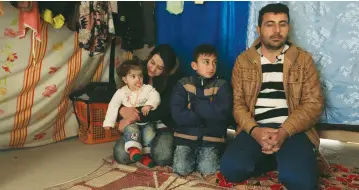  ??  ?? KHUDEEDA RASHOWKA NAIF and his family sit inside a tent at a refugee camp near Duhok, Iraq.