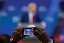  ?? Photograph: Erik S Lesser/EPA ?? A person takes a photo as Donald Trump speaks during CPAC in Maryland on 29 February 2020.