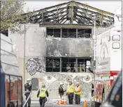  ?? ERIC RISBERG / ASSOCIATED PRESS ?? Members of the Alameda County Sheriff’s Office stand outside the site of a fatal weekend warehouse fire in Oakland, Calif., on Wednesday. Recovery efforts at the site have ended, officials said.