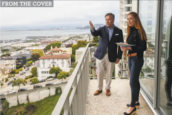  ?? Josie Norris / The Chronicle ?? Realtor Gregg Lynn points out the view of the Golden Gate Bridge to Whitney Hudak while showing a condo at 1080 Chestnut St. on San Francisco’s Russian Hill.