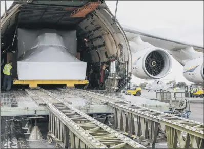  ?? PICTURES: PA WIRE. ?? HUGE ARRIVAL: A flight training simulator for new submarine-hunting jets, is unloaded from the Antonov AN-124.