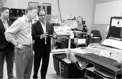  ?? STEVEN LEMONGELLO/STAFF ?? Voxx Automotive president Edward Mas gives Florida Agricultur­e Commission­er Adam Putnam a tour of the facility near Lake Nona on Thursday.