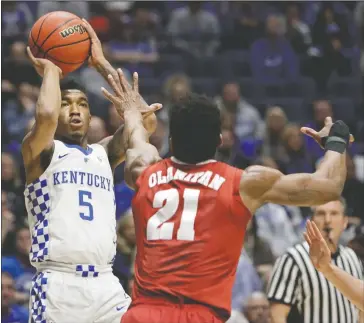  ?? The Associated Press ?? SHARP SHOOTER: Kentucky guard Malik Monk (5) shoots over Alabama forward Bola Olaniyan (21) in the first half of the Southeaste­rn Conference tournament semifinals Saturday in Nashville, Tenn. The Bentonvill­e native scored 20 points in Kentucky’s 79-74...