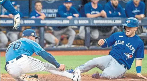  ?? STEVE NESIUS “You want to show everybody that you belong and you want to do well,” said Jays outfielder Daulton Varsho, scoring on a wild pitch Tuesday against Tampa Bay. THE ASSOCIATED PRESS ??