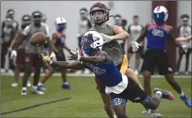  ?? (Arkansas Democrat-Gazette/Stephen Swofford) ?? Arkadelphi­a wide receiver Jay Purifoy (bottom) dives for the ball as Benton safety J Thomas Pepper blocks his catch during a 7-on-7 tournament game Monday at Benton High School.