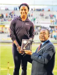  ?? PHOTO BY PAUL CLARKE ?? Shelly-Ann Fraser-Pryce collecting the Key to the City of Montego Bay from Mayor, Councillor Glendon Harris, at the Montego Bay Sports Complex at the weekend.