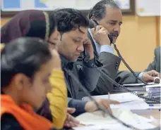  ?? — AFP ?? Employees of Pakistan Bureau of Statistics and the headquarte­rs of Population Census 2017 speak on public helplines to give informatio­n about census in Islamabad on Monday.