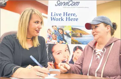  ?? SHARON MONTGOMERY-DUPE/CAPE BRETON POST ?? Dani Mombourque­tte, left, a recruiter for ServiCom in Sydney, chats with Sherry Lambert of Glace Bay during a job fair hosted by the YMCA of Cape Breton Nova Scotia Works Employment Services Centre on Reserve Street in Glace Bay on Tuesday. ServiCom...