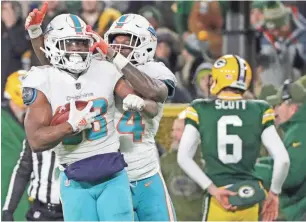  ?? ADAM WESLEY/USA TODAY NETWORK-WISCONSIN ?? Leonte Carroo celebrates after recovering a blocked punt that led to a field goal for the Dolphins on Sunday.