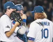  ?? Wally Skalij Los Angeles Times ?? DODGERS starting pitcher Rich Hill, left, confers with catcher Yasmani Grandal and third baseman Justin Turner.