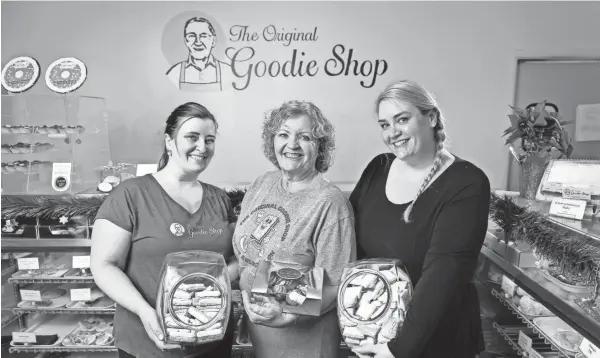  ?? ADAM CAIRNS/COLUMBUS DISPATCH ?? Debbie Smith and her two daughters, Emilie Smith, left, and Miranda Smith, who all co-own the Original Goodie Shop in Upper Arlington hold a variety of cookie offerings, including the German springerle­s.