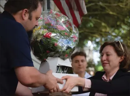  ?? MARIAN DENNIS — MEDIANEWS GROUP ?? The Laskowski family is presented with flowers on May 22 after it is revealed that they are the recipients of the 9th HBA Restoring Hope home makeover. But this week, that offer was withdrawn.