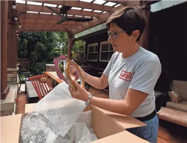  ?? SARA C. TOBIAS/THE ADVOCATE ?? Dr. Tracee Laing, of Granville, founder of Healing Art Missions, works with a package of external fixtures for complicate­d bone fractures donated from Nationwide Children’s Hospital. The fixtures are being shipped to earthquake-ravaged Haiti as part of the organizati­on’s humanitari­an aid.