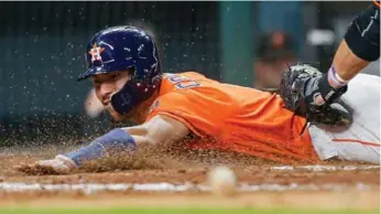  ?? BOB LEVEY/GETTY IMAGES ?? Houston’s Carlos Correa played through pain for a while after jamming his left thumb into a catcher’s shin guard.