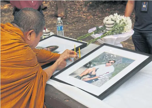  ??  ?? JOINED IN PRAYER: People attend a religious ceremony in Fresno County after a recovery team retrieved the bodies of the Thai students on Sept 1.