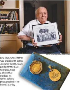  ?? STAFF PHOTOS BY DOUG STRICKLAND ?? Lew Boyd, whose father was chosen with Bobby Jones for the U.S. team picked for the 1920 Olympics, holds a photo that includes his father as he is photograph­ed in his home Saturday.