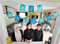  ?? JOHN RENNISON THE HAMILTON SPECTATOR ?? Salma Seta, centre, with her children Laaibah, 14, left, and Muhammad, 10, and some of their decoration­s for Eid.