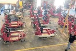  ?? DEWAYNE BEVIL/STAFF ?? Roller-coaster cars await full assembly at Orlando-based Skyline Attraction­s. The vehicles are for a thrill ride at Six Flags Discovery Kingdom theme park in California.