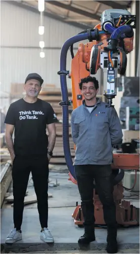  ??  ?? Design Indaba founder Ravi Naidoo (L) and Jamie Smily (R) from Xlab pose next to ALEX the robot. They are currently working on a project using ALEX to build a cross-laminated timber bridge over the Liesbeek River, Cape Town. Phot0 by Shelley Christians