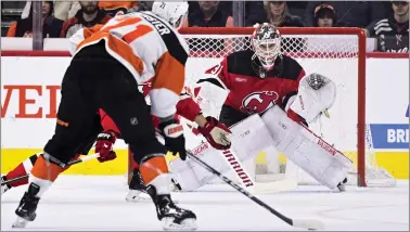  ?? DERIK HAMILTON — THE ASSOCIATED PRESS ?? New Jersey Devils goaltender Kaapo Kahkonen, right, looks for a shot from the Flyers’ Tyson Foerster during the first period Saturday at Wells Fargo Center.