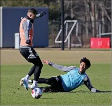  ?? (STUART CAHILL — BOSTON HERALD ?? New England Revolution Victor Souza slide tackles New England Revolution forward Giacomo Vrioni (9) (standing) as the Revolution practice at their facility on January 27, 2023 in , Foxboro, MA